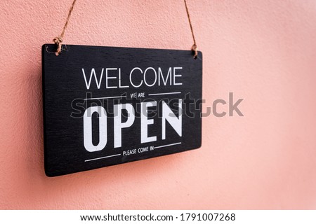 Come in we're open, vintage black retro sign in pink wall