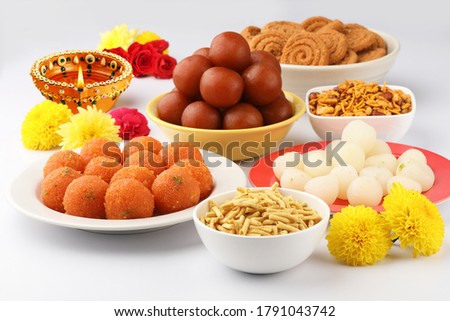 Indian festive Diwali Sweets ,traditional  snacks with  decorative lamp with flowers