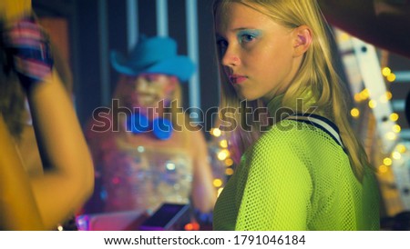  Young stylish woman dancing in the nightclub. Dancers having fun at a party in a night club. People's lifestyle DJ nightlife.