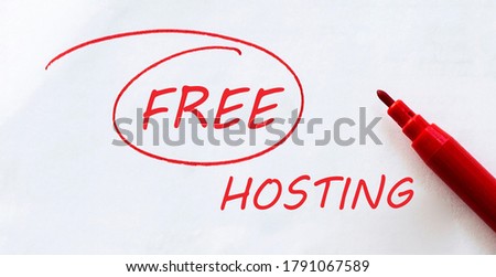white paper with text Free Hosting on the white with red marker