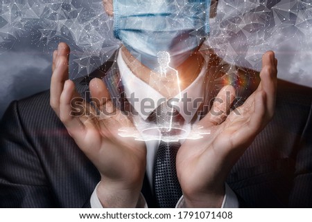 A businessman in a mask supports a hologram of an employee on a blurred background.