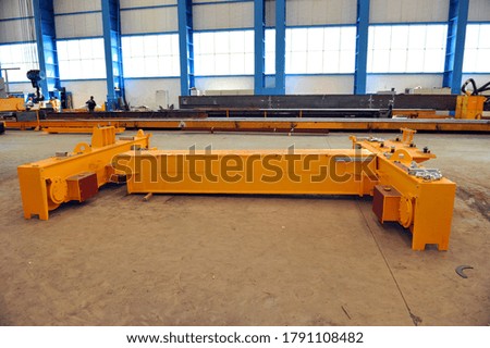 Overhead crane and concrete floor inside factory building for industrial background