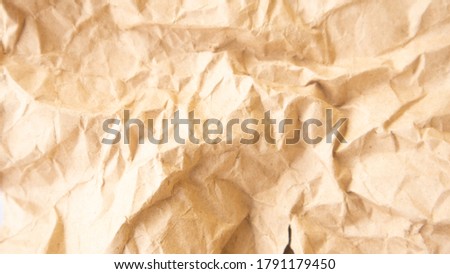 Light brown rippled paper useful as a background. Closeup of brown wrinkled paper texture background