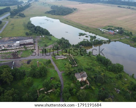 small village near a lake in summer aerial photo.
