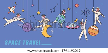 Several planets are adorned like mobiles, and astronauts are playing happily in them. flat design style minimal vector illustration.