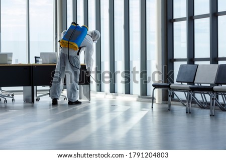 Cleaning and Disinfection at office amid the coronavirus epidemic Professional teams for disinfection efforts Infection prevention and control of epidemic Protective suit and mask. Royalty-Free Stock Photo #1791204803