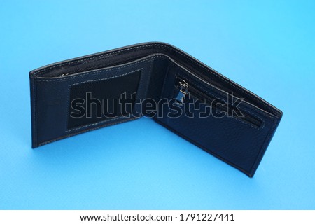wallet black leather open on a blue background
