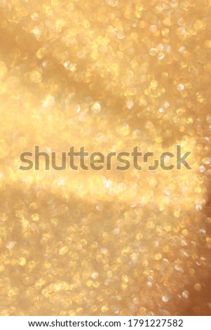 Gold and golden yellow glitter bokeh circle glow  blurred and blur abstract. Glittering shimmer bright luxury . White and silver glisten twinkle for texture wallpaper and background backdrop.