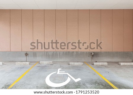 Empty Parking on the ground floor below the apartment building for the disabled