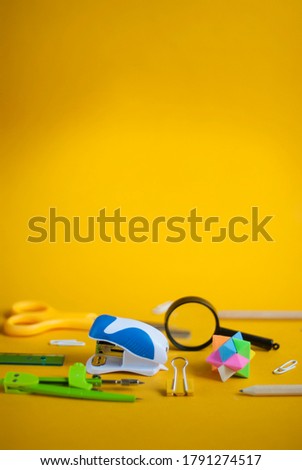 School office supplies. Back to school concept. Stationery on a bright yellow background with place for text.