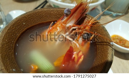 Vertical view of bamboo herbal prawn with blury background. Savour the sweetness of live prawns, with the light fragrance of nourishing chinese herbs.