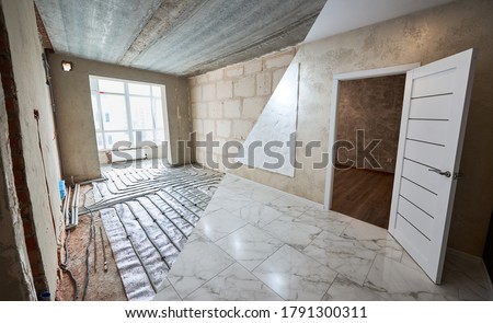 Comparison of new renovated room with open door and old place with large window and underfloor heating pipes. Modern apartment before and after restoration. Concept of home renovation. Royalty-Free Stock Photo #1791300311