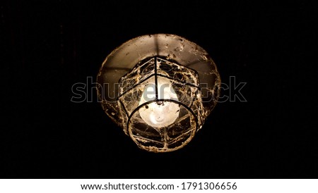 Lamp design dark background for exterior and interior. Spider web on its structure.