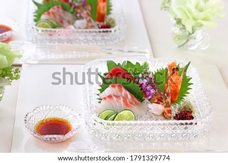 Plate of assorted fresh sashimi.
Tuna, sea bream, japanese tiger prawn.
The condiments are sliced white radih,
radish, perilla, perilla flowers,
and sudachi.