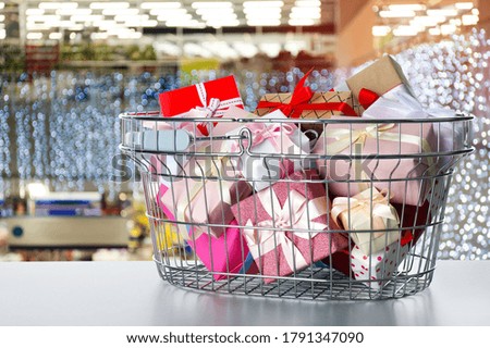 Boxing day concept. Shopping basket with gifts in supermarket