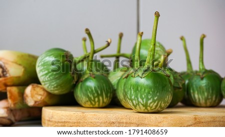 Close up of small green eggplant on the table Royalty-Free Stock Photo #1791408659