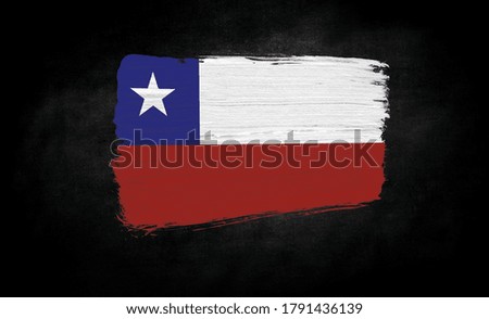 smear of paint in the form of the flag of Chile close-up on a black background