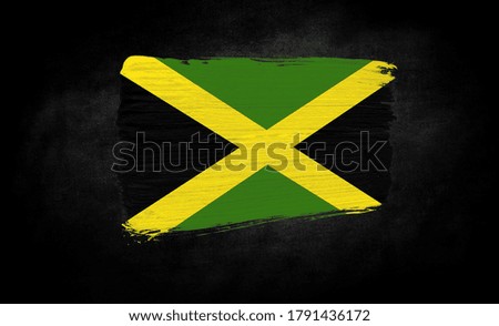 smear of paint in the form of the flag of Jamaica close-up on a black background