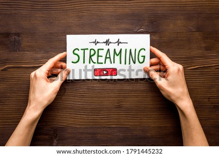 Live streaming web network concept. Female hands holding paper tablet. Top view