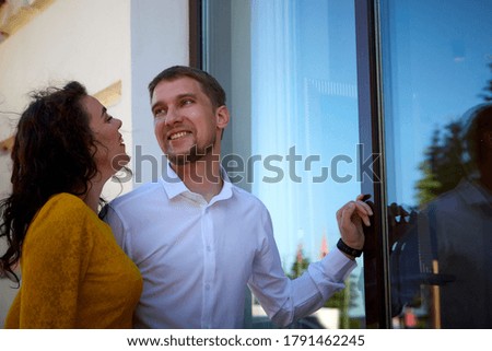 A date between a young girl and a guy on a Sunny summer day. Young beautiful couple on a walk in the city. Man and woman at a love meeting with hugs and kisses outdoors