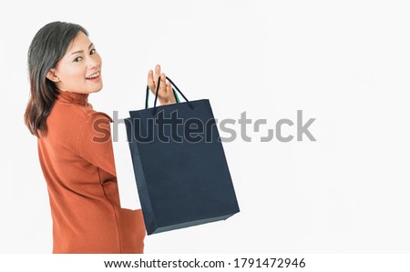 Shopping Asia woman holding paper bag isolated on white background.focus on face