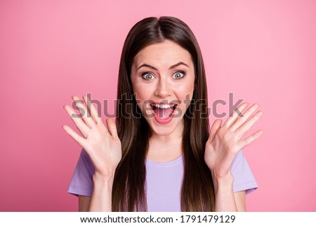 Closeup photo of attractive funny shocked lady good mood smiling teeth long hairdo open mouth listen nice news raise arms wear casual violet t-shirt isolated pink pastel color background