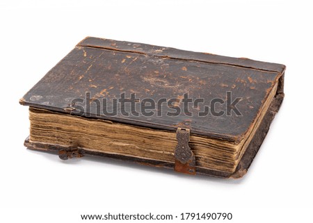  A brown book, in shabby leather case with clasps. Close-up, horizontal shot.