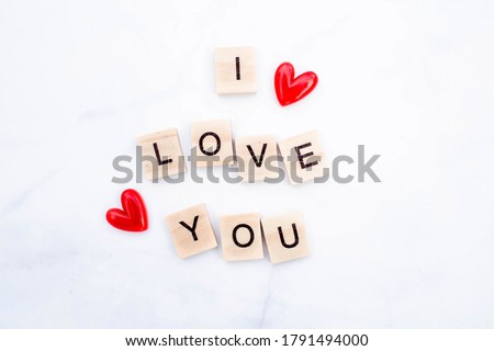 The word Love. Love on wooden cubes. Love theme. Valentine's day. Wood letter blocks with word Love. Loving, positive emotions. Wood cubes with word. Feelings backdrop. Exclusive relationships. Royalty-Free Stock Photo #1791494000