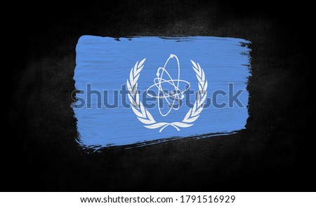 smear of paint in the form of the flag of IAEA close-up on a black background