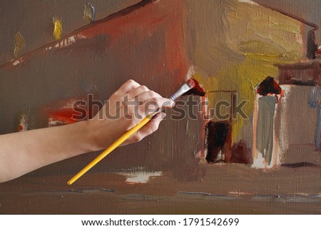 Woman hand close up painting