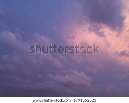 it is a picture of pinkish blue sky with clouds