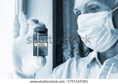 The concept of a Coronavirus trial vaccine is in the hand of scientist in white gloves. Development and creation of a coronavirus vaccine COVID-19, vertical photo
