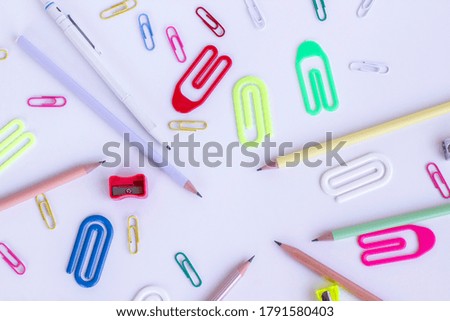 Colorful school supplies on the white surface with.