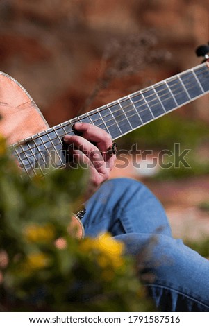 Guitarist playing outside in nature