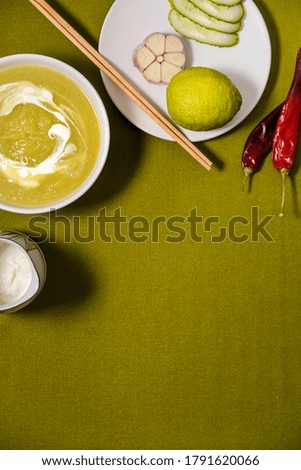 squash zucchini creamy soup with vegetables. top view. dark background with linen cloth