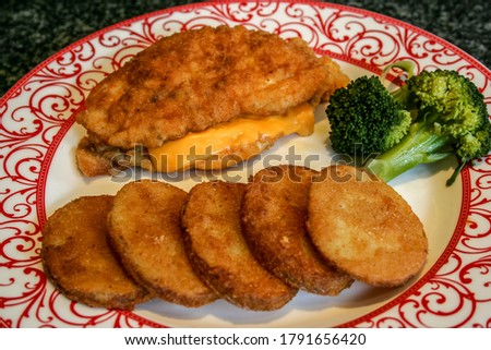 Cheesy Chicken Schnitzel with Steamed Broccoli and Mojos on the side