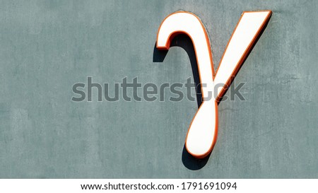 large letter gamma on a grey background