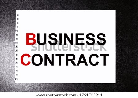 business contract. text on white sheet of paper on black background