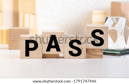 Letter block in word pass on wood background