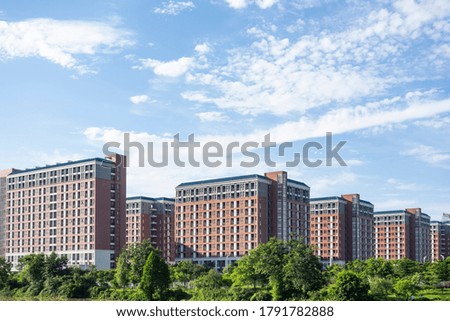 Neat urban buildings under blue sky and white clouds