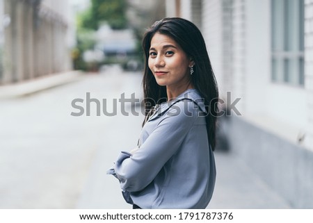 Portrait of a cute young businesswoman smiling outdoor blur background, Portrait woman happy and confident.