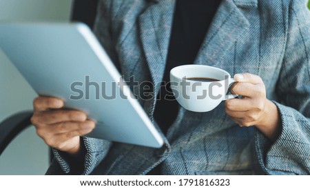 Closeup image of a business woman using digital tablet in office