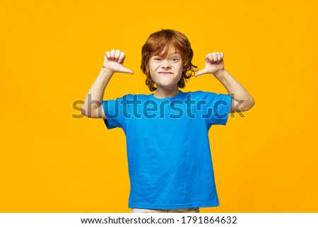 redhead boy grimacing at camera and gesturing with his hands angry facial expression emotions 