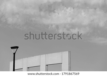 picture of the sky and a lamp post in black and white