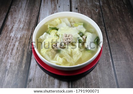 Traditional clear soup of Chinese cabbage and marinated (minced) pork in the bowl. Famous hot and freshness soup menu in Chinese restaurant.  Royalty-Free Stock Photo #1791900071