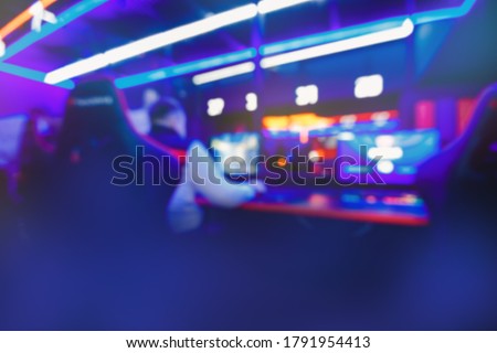 Blurred background professional team gamer stream playing tournaments online games computer with headphones, red and blue.