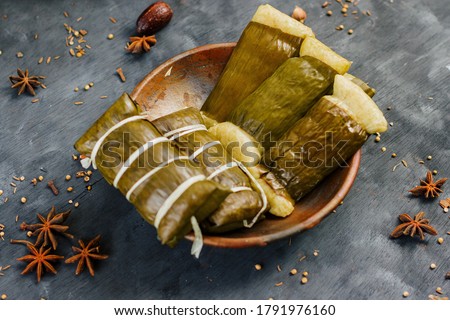 Burasa or buras is a type of Indonesian rice dumpling, cooked with coconut milk packed inside a banana leaf pouch. It is a delicacy of the Bugis and Makassar people of South Sulawesi, Indonesia. Royalty-Free Stock Photo #1791976160
