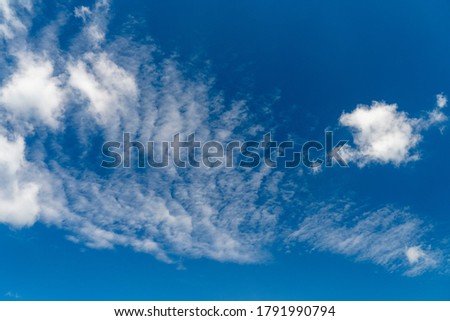 Cirrus clouds on a sultry summer day. A rare view of cirrus clouds on a calm day. Spindrift clouds.