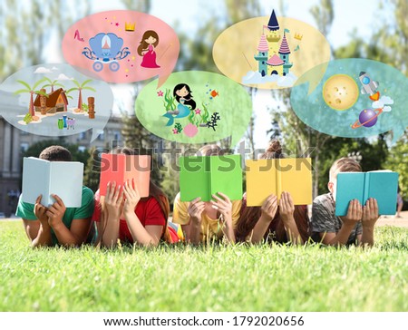 Children reading books outdoors on sunny day