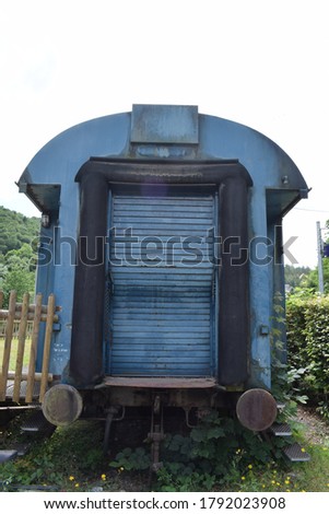 old blue railroad car at station Monreal